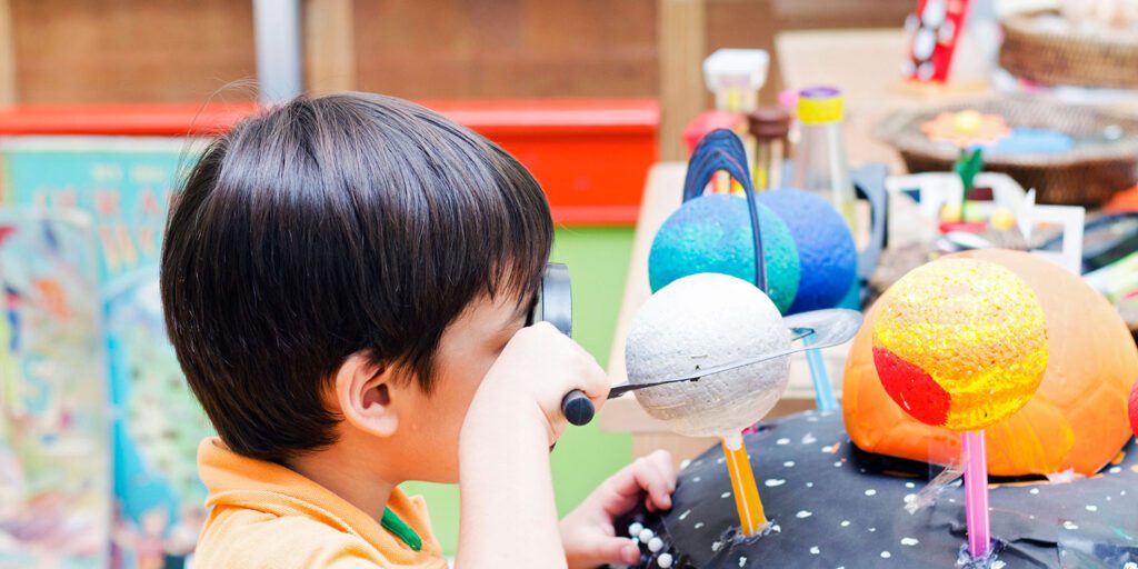 Elementary student working on a science project in a classroom